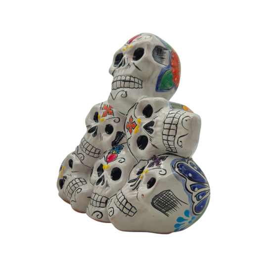 Side view of a colorful Talavera stacked skulls ceramic statue