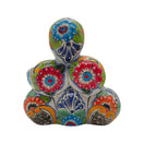 Back view of a colorful Talavera stacked skulls ceramic statue with floral designs