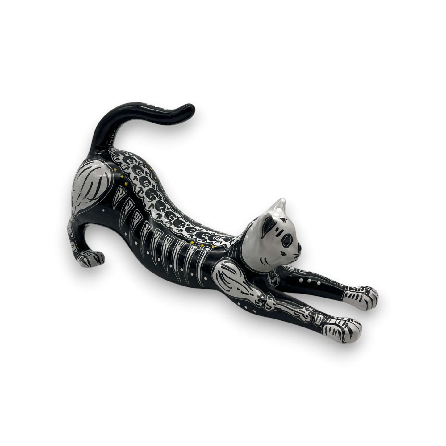 Talavera Stretching Cat Figurine | Hand-Painted Calavera Art - hand-painted black ceramic cat with white skeletal motifs and red floral accents
