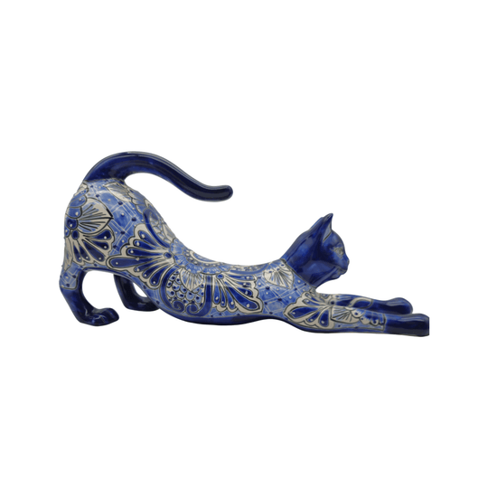 Front view of a blue and white Talavera cat statue with expressive face