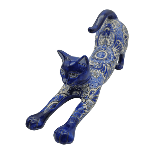 Top angle view of a blue and white Talavera stretching cat statue