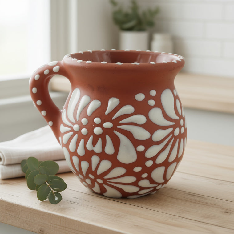 Ceramic mug with white floral patterns on a wooden surface