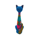 Rear view of a tall ceramic Alebrije cat statue with colorful floral and geometric details