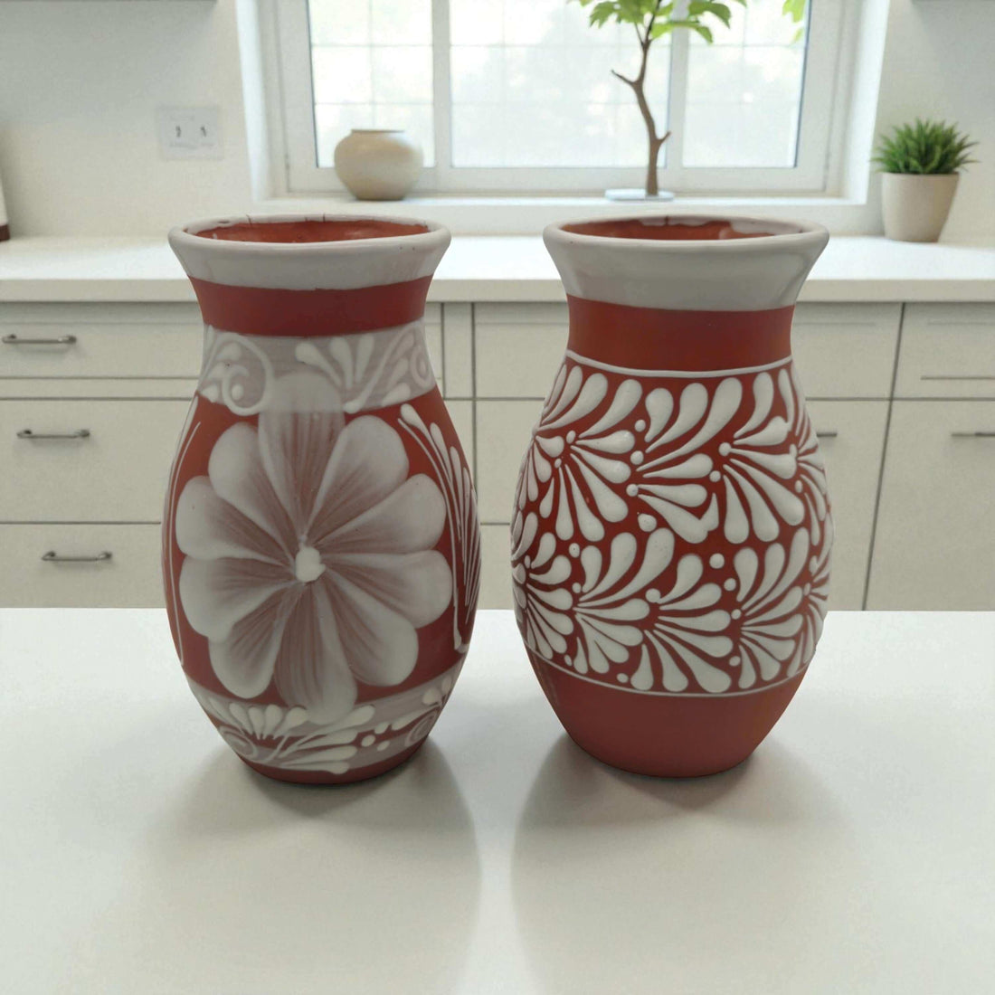 Terracotta Talavera Vase | Mexican Hand-Painted Pot - pair of hand-painted terracotta vases with white floral Talavera designs on kitchen countertop