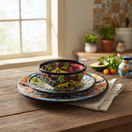 The Talavera Hub 43-piece Talavera dinnerware set with vibrant floral patterns and a blue rim. Hand-painted ceramic tableware for 8.