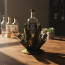 The Talavera Hub Mexican Tequila Decanter Set with 6 shot glasses, shaped like an agave plant, made of metal with green finish.