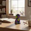 The Talavera Hub hand-painted ceramic Alebrije dog figurine with vibrant blue, green, and purple Mexican folk art patterns.