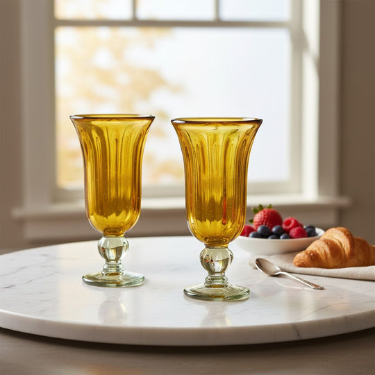 The Talavera Hub hand-blown amber glass sundae dishes with ribbed texture and green-tinted bases. Set of 2.