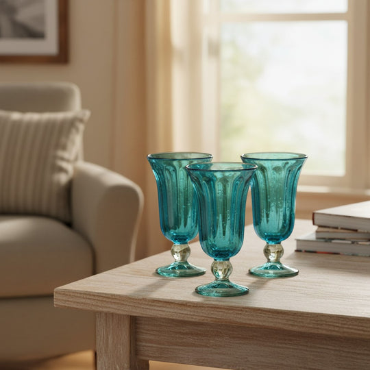 The Talavera Hub hand-blown aqua teal fluted sundae glasses, set of 4, with clear bases and twisted stems.