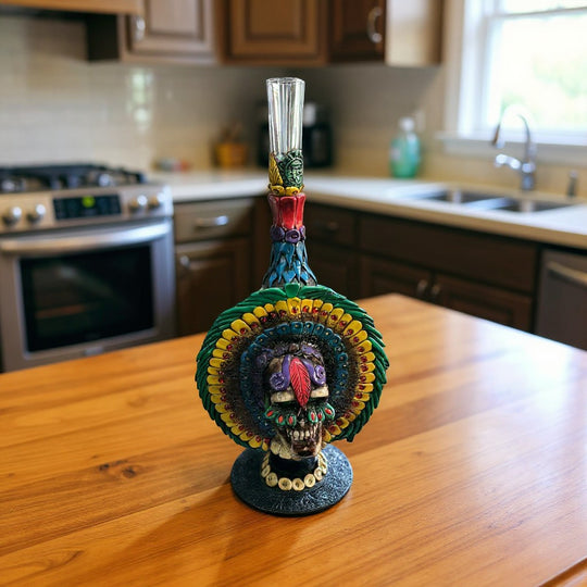 The Talavera Hub handcrafted Aztec warrior skull decanter with colorful headdress and glass top.