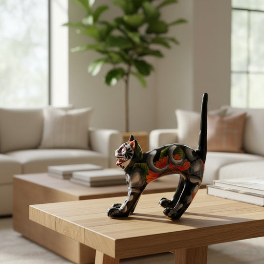 The Talavera Hub handmade black ceramic cat statue with colorful floral and Day of the Dead inspired designs.