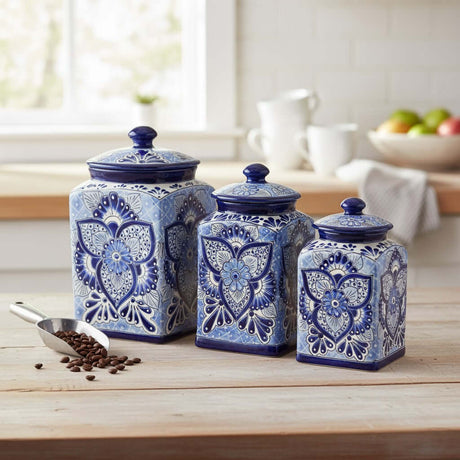 The Talavera Hub handmade blue and white ceramic canister set with traditional floral patterns on a wooden table.