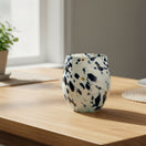 The Talavera Hub hand-blown stemless wine glass with blue, mocha, and white speckles. Holds 12 oz.