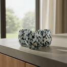 The Talavera Hub hand-blown stemless wine glass with blue, mocha, and white speckle design. Holds 12 oz.