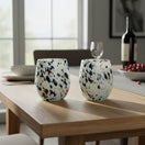 The Talavera Hub hand-blown stemless wine glass with blue, mocha, and white speckles. Holds 12 oz.