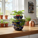 The Talavera Hub blue ceramic strawberry planter with peacock feather design, 10.5" tall.