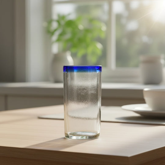 The Talavera Hub hand-blown clear glass tumbler with a cobalt blue rim, 18 oz capacity.