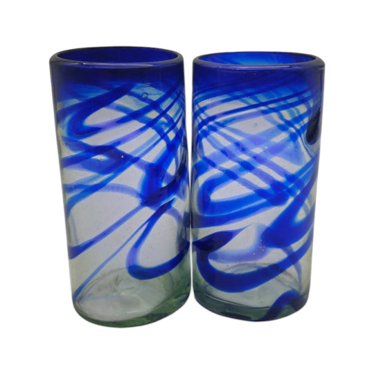 The Talavera Hub hand-blown Mexican drinking glasses with blue swirl design. Clear glass with cobalt blue accents.