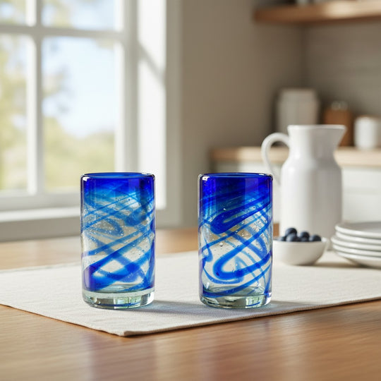 The Talavera Hub blue swirl hand-blown recycled glass tumbler, 16 oz, 5" tall. Perfect for water, juice, or cocktails.