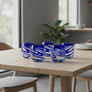 The Talavera Hub hand-blown stemless wine glasses with blue swirls. Set of 6 glasses made from recycled glass.
