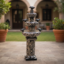 The Talavera Hub blue and white ceramic tiered fountain with bird accents and floral patterns. Handmade in Mexico.