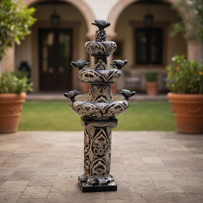 The Talavera Hub blue and white ceramic tiered fountain with bird accents and floral patterns. Handmade in Mexico.