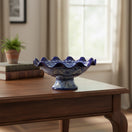 The Talavera Hub hand-painted blue and white ceramic fruit basket with scalloped rim and intricate floral patterns.