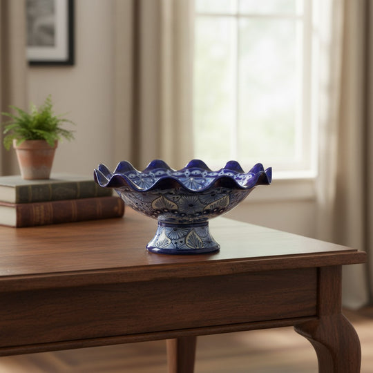 The Talavera Hub hand-painted blue and white ceramic fruit basket with scalloped rim and intricate floral patterns.