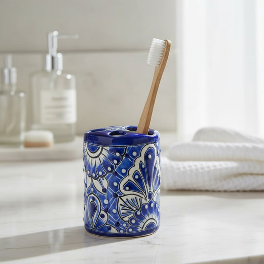 The Talavera Hub hand-painted ceramic toothbrush holder in blue and white with traditional floral Mexican motifs.