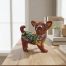 The Talavera Hub brown ceramic Chihuahua dog figurine with colorful floral and geometric Talavera patterns.