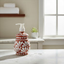The Talavera Hub handcrafted ceramic soap dispenser featuring a brown and white floral pattern on a bathroom counter.