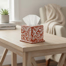 The Talavera Hub square tissue box featuring a hand-painted brown and white floral pattern on a wooden table.