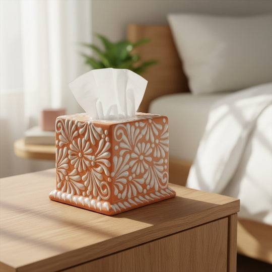 The Talavera Hub square tissue box featuring a hand-painted brown and white floral pattern on a wooden nightstand.