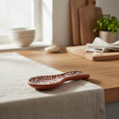 The Talavera Hub brown and white handcrafted ceramic spoon rest with floral pattern, ideal for kitchen countertops.