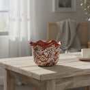 The Talavera Hub brown and white ceramic planter with wavy rim and floral motifs. Handcrafted in Mexico.