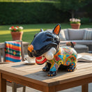 The Talavera Hub hand-painted ceramic Bull Terrier decor with bone, featuring a black body and colorful Talavera patterns.