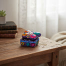 The Talavera Hub butterfly-shaped ceramic jewelry box with vibrant hand-painted floral patterns on a wooden table.