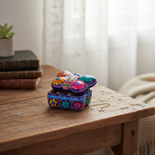 The Talavera Hub butterfly-shaped ceramic jewelry box with vibrant hand-painted floral patterns on a wooden table.