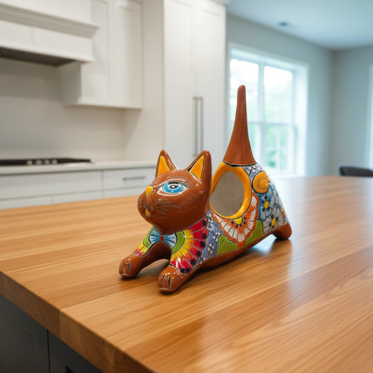 The Talavera Hub handcrafted ceramic stretching cat planter, hand-painted with colorful flowers in blue, red, yellow, and green.