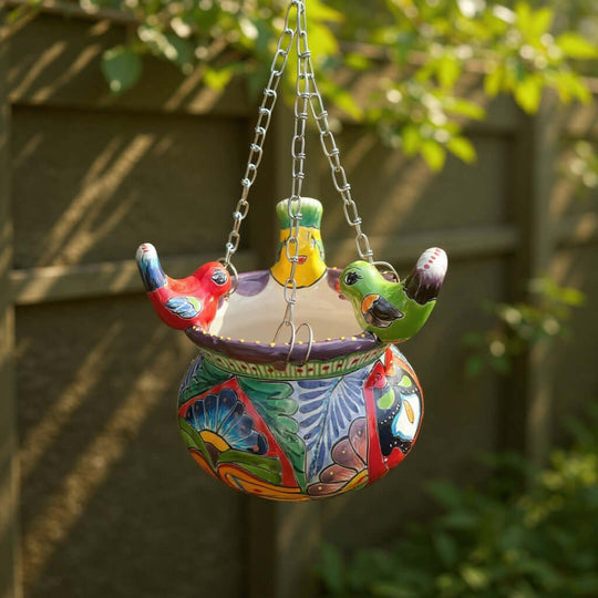 The Talavera Hub handmade ceramic hanging planter with colorful bird accents and traditional Mexican floral patterns.