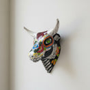 The Talavera Hub handcrafted ceramic bull skull wall art with vibrant Day of the Dead floral and skeletal patterns.