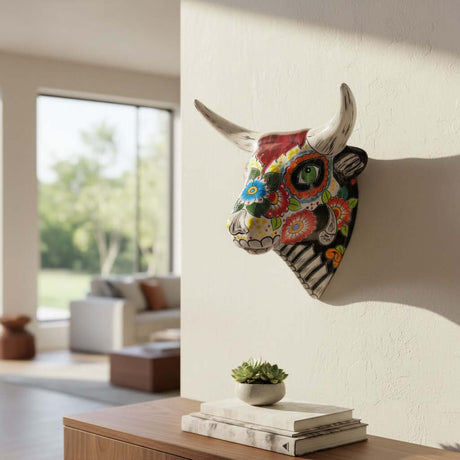 The Talavera Hub handcrafted ceramic bull skull wall art with vibrant Mexican floral Day of the Dead patterns.