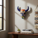The Talavera Hub handmade ceramic bull skull wall decor with vibrant floral and geometric patterns in a home interior.
