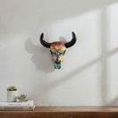 The Talavera Hub handmade ceramic bull skull wall decor with vibrant hand-painted floral patterns on a white wall.