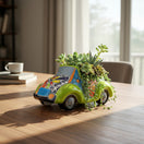 The Talavera Hub hand-painted ceramic car planter in lime green with colorful floral Talavera patterns.