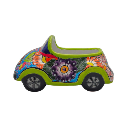 The Talavera Hub small ceramic car planter with vibrant hand-painted floral folk art patterns in green and purple.