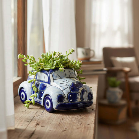 The Talavera Hub handmade blue and white ceramic car planter with a succulent, displayed on a rustic windowsill.