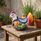 The Talavera Hub handcrafted Mexican ceramic chicken planter with vibrant floral motifs on a rustic wooden table.