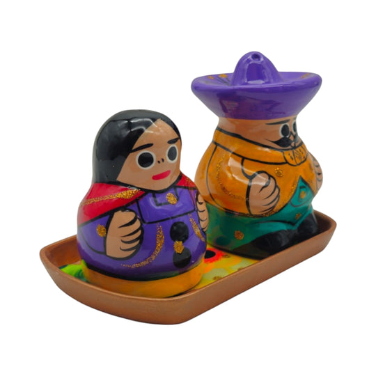 The Talavera Hub hand-painted ceramic salt and pepper shakers featuring a couple on a matching tray in vibrant colors.