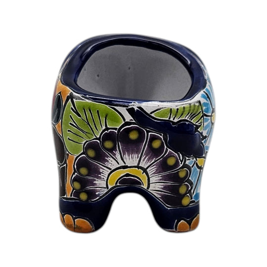 The Talavera Hub hand-painted ceramic elephant planter with colorful floral patterns in blue, green, and yellow.